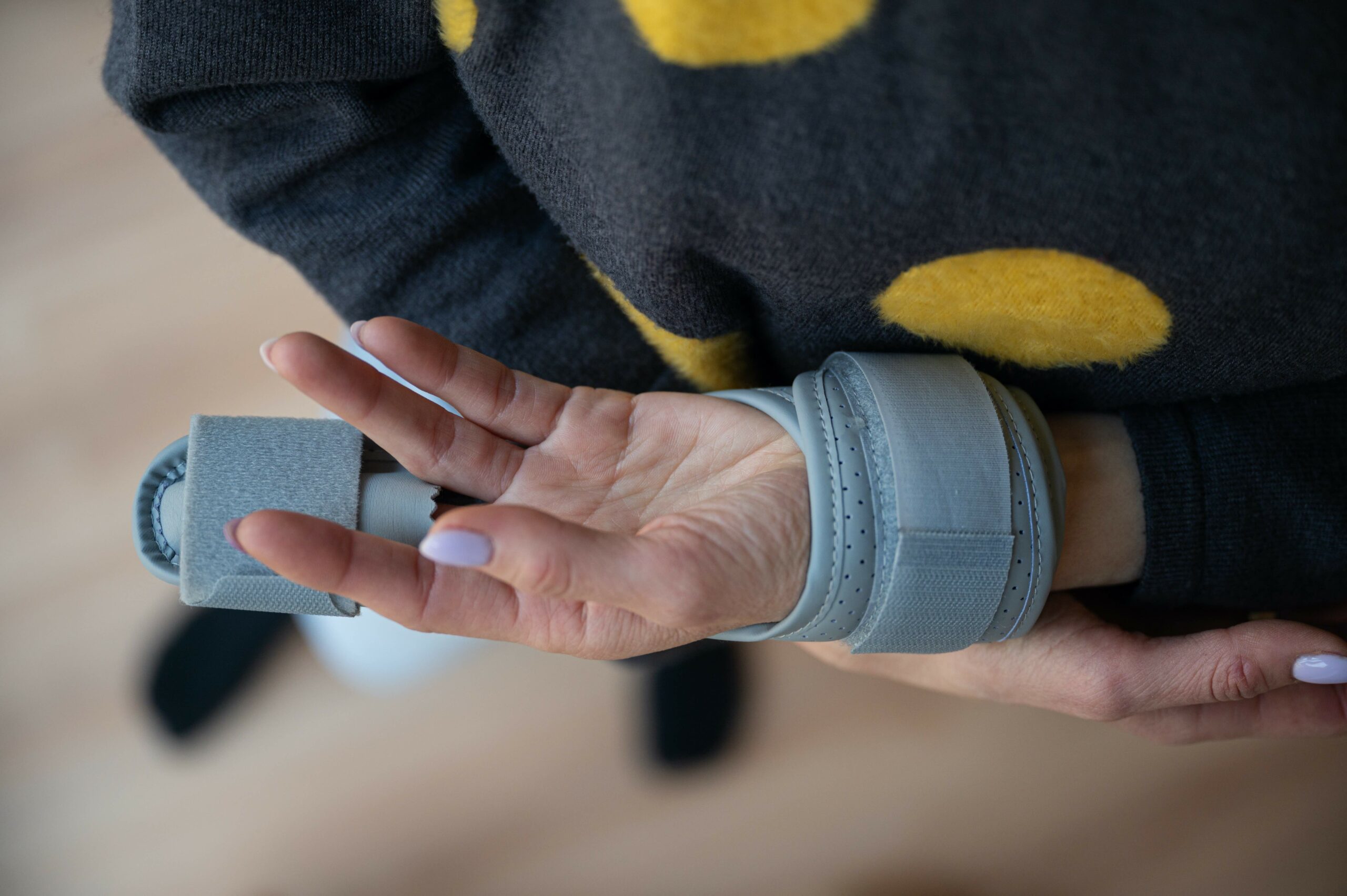 Woman wearing a brace on broken finger